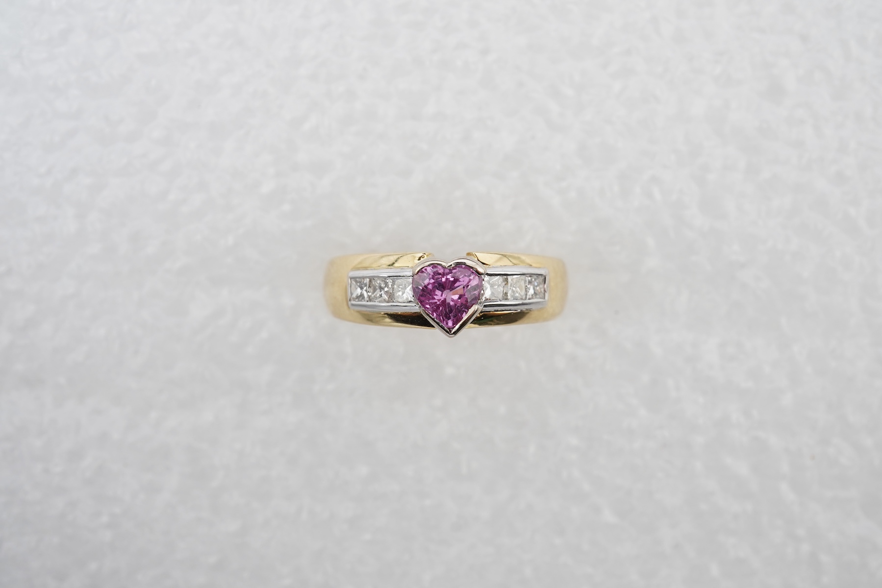 A pink sapphire and diamond ring